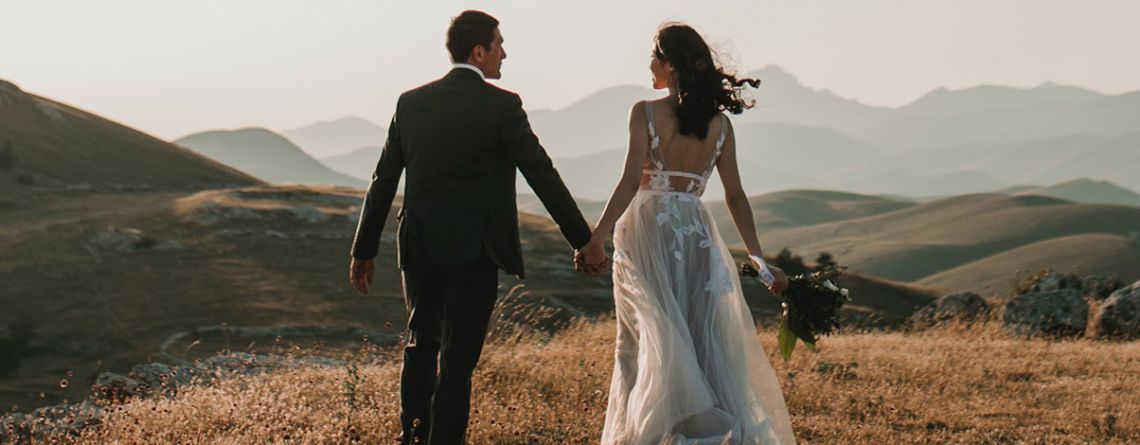 Bride and Groom standing together in nature