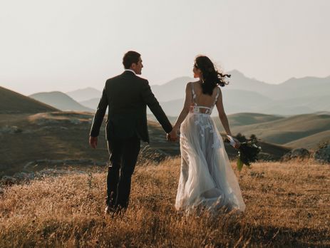 Bride and Groom standing together in nature
