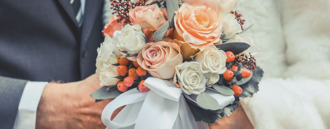 Bride and Groom holding flowers